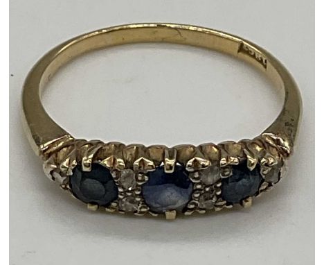 An 18ct yellow gold sapphire and diamond ring set with three sapphires and six tiny diamonds, size R, approx 3.06g. 