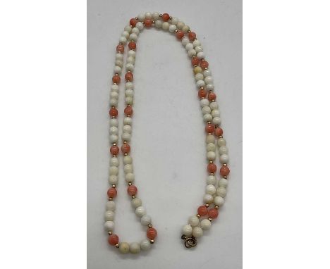 A vintage coral and stained coral bead necklace set with 9ct gold clasp and yellow metal spacers, length approx 70cm.