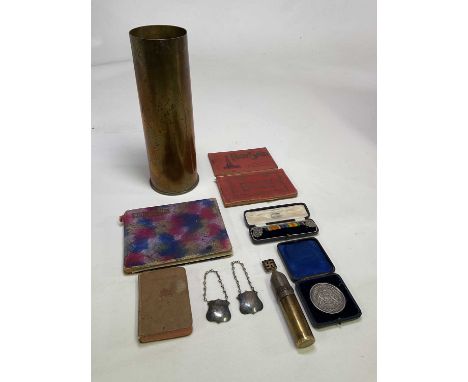 An interesting group of collectors' items including a brass shell case, a small casing converted to a lighter, an autograph b