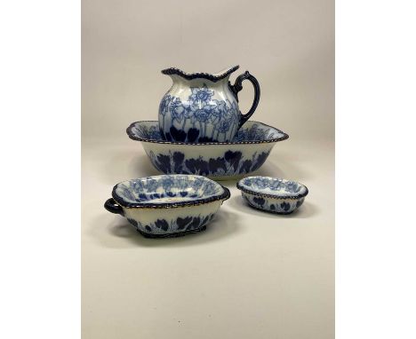An Art Nouveau inspired blue and white pottery toilet jug, bowl, soap dish and stand, and small dish and stand, retailed thro