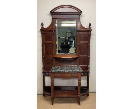 A Victorian mahogany hallstand, with central bevelled mirror, flanked to each side by five brass coat hooks, above a marble s