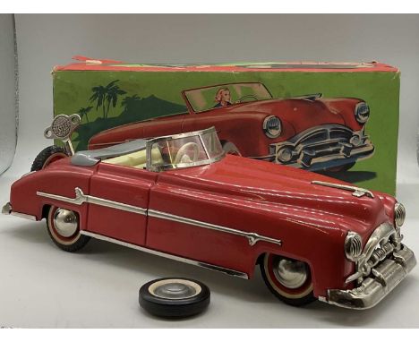 DISTLER; a tin plate convertible car with red body and cream interior, with original box, a key and a spare wheel it measures