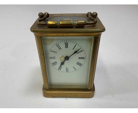 A circa 1900 French brass carriage clock, the white enamelled dial set with Roman numerals, height 11.5cm