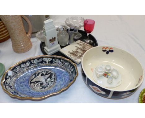 An Arcadian china cenotaph model; a miniature crested ware tea set; a tile depicting Caernarvon Castle; a pottery bowl; New H