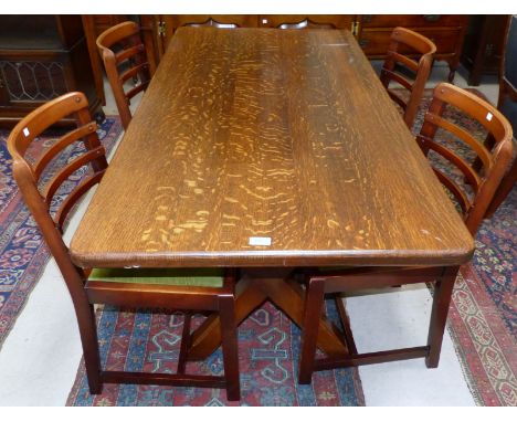 An oak refectory style dining table with apex supports and four ladder back dining chairs