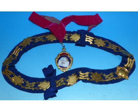 A silver gilt and enamel LVA medallion and chain