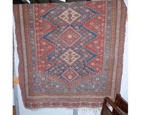 An antique flat sumac carpet with 5 central diamond reserves, on blue and red grounds, multi-bordered and fringed, 86" x 66"