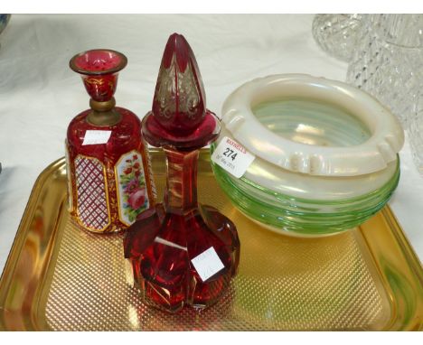 An Art Nouveau iridescent glass bowl with trailed green decoration; a 19th century overlaid scent bottle (a.f.); a 19th centu