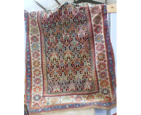 A small Eastern hand knotted carpet with geometric central panel, multi bordered and fringed, dated 1880, 108" x 60"