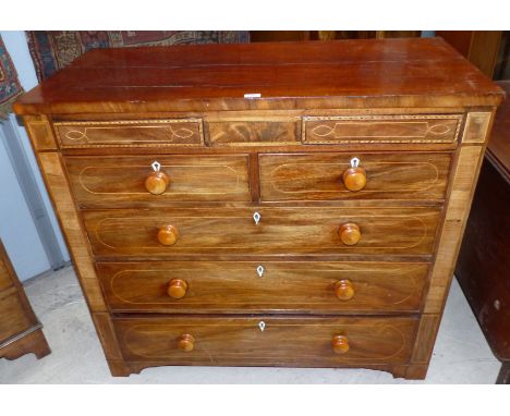 An early 19th century inlaid mahogany chest of 3 long, 2 short and 2 frieze drawers, on bracket feet