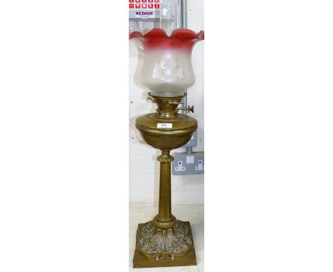 A Victorian brass oil lamp with ruby border shade and chimney (shade a.f.)