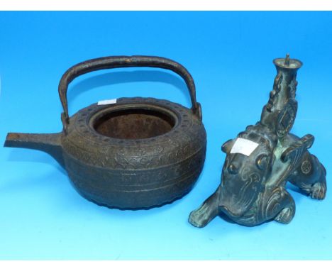 An antique Japanese tetsubin cast iron kettle (no lid); an oriental bronzed pricket candlestick