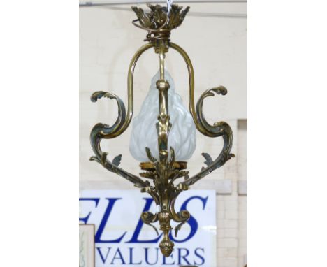 A decorative brass pendant ceiling / hall light with frosted glass flame shaped shade