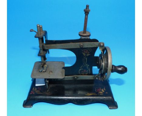 A child's vintage toy sewing machine