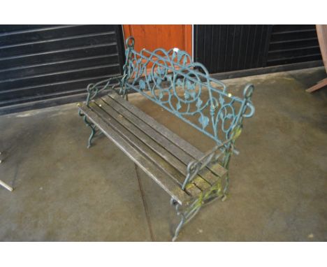 A wooden and metal garden bench with vine decoration