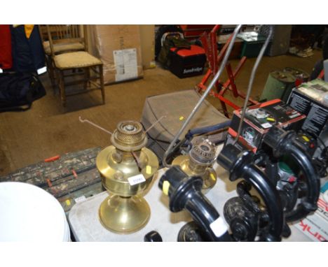 A hanging oil lamp and one other lacking shades and chimneys