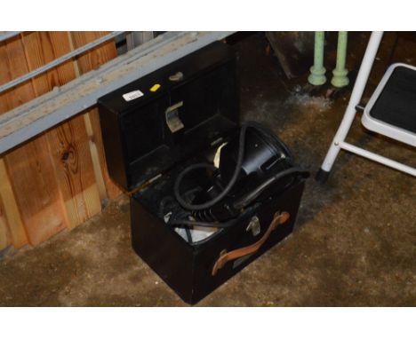 A large spot lamp in fitted case