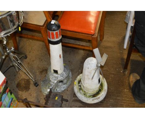 Two concrete garden ornaments in the form of light house and a windmill