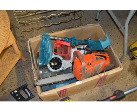 A box of various tools to include petrol chain saw, car battery charger, paraffin blow lamp, etc.