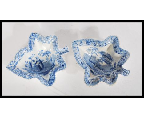 A pair of 19th century Spode blue and white pickle dishes in the form of leaves. One with girl at water pump design, the othe