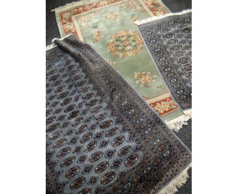 JADE GREEN CHINESE WASHED WOOLEN RUG with a rust floral border, 140 x 200cms together with two blue ground Persian rugs, 80 x
