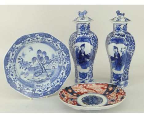 PAIR OF CHINESE UNDER-GLAZED BLUE PORCELAIN VASES of faceted baluster form with narrow necks and dog-of-fo finial covers, tog