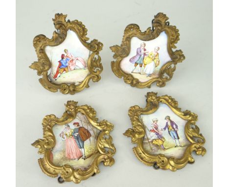 SET OF FOUR FRAMED ENAMEL PLAQUES depicting period figures in dress (4)The enamel is 7x5cms.With frame 8.5x10cms. There is a 