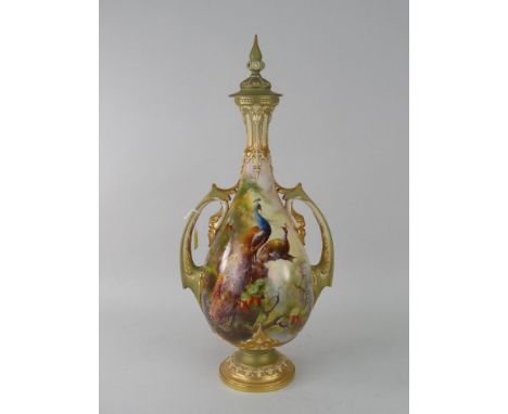 ROYAL WORCESTER PORCELAIN COVERED VASE with narrow neck over a circular pedestal foot, ornate twin-handles and finial, finely