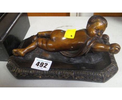 COLD CAST MODEL OF A RECLINING CHILD, signed 'Della Robbia'