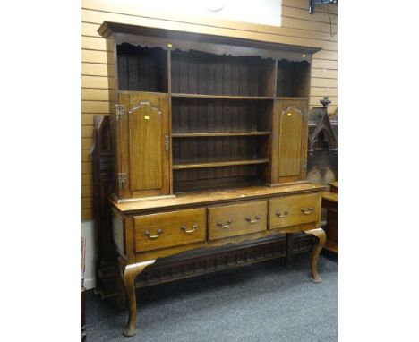 GOOD ANTIQUE OAK DRESSER with a three shelf top flanked with cupboards with an open three drawer base on raised cabriole legs