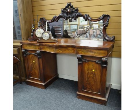 GOOD ANTIQUE MAHOGANY MIRROR BACKED BOW FRONT SIDEBOARD, two cupboard base and three drawers and ornately carved back panel, 