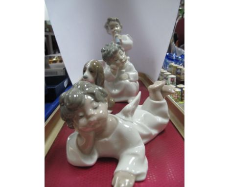 Three Lladro Figures of Winged Cherubs and a Seated Spaniel Dog.