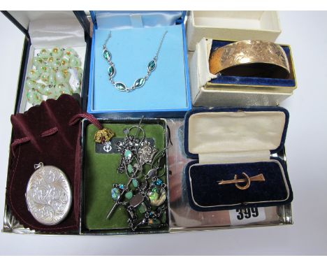 A Vintage Style Bar Brooch, with horse shoe detail, stamped "9ct", in a fitted case, a hallmarked silver oval locket pendant,