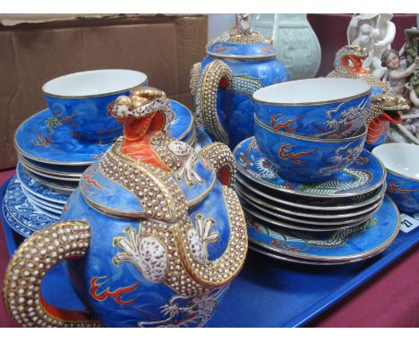 A Japanese Tea Service, on a blue ground, spouts in the form of a dragons head, Royal Doulton plates decorated with dragon:- 