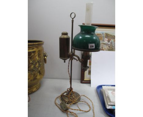 A Students Brass Oil Lamp, (converted) with a green shade, glass funnel, on a circular base.