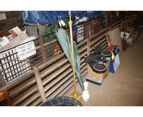 A bowling pin together with a gilt standard lamp and a fishing brolly 