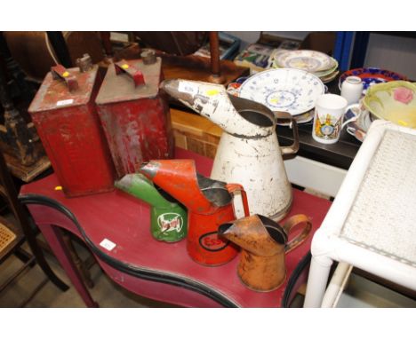 An Esso oil can together with a Castrol oil can and two others