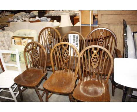 A set of six stick and wheel back chairs to include two carvers 