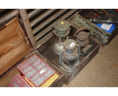 A drawer and contents of a hurricane lamp; a tilly lamp and a signal lamp