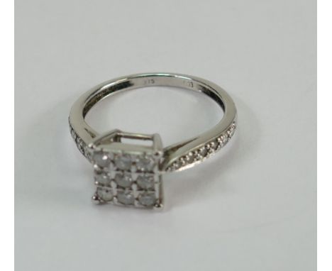 9ct white gold diamond set ladies dress ring. 9 diamonds set in a square, plus a further 4 diamonds in each shoulder. 0.33ct.