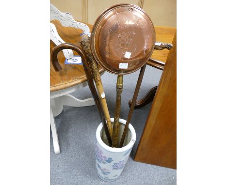A ceramic floral umbrella stand with 3 walking sticks, including a knotted bamboo stick, and a brass bed pan (5)