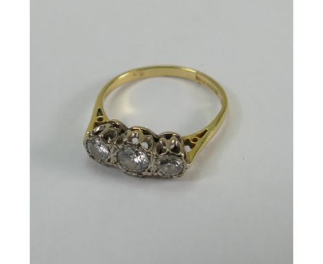 18ct yellow gold 3 stone diamond ring - 1 x 20 points & 2 x 10 points appx. Size K. 2.2g. Very minor dents to shank.