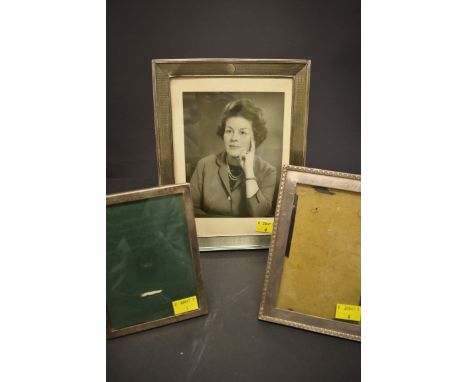 An engine turned rectangular photograph frame, by Walker &amp; Hall, Birmingham 1938?, 25cm x 19.5cm; together with two simil