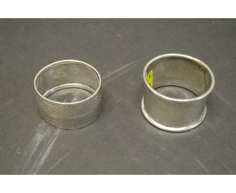 An engine&nbsp;turned silver napkin ring, Chester 1923; together with a plain silver example, 48.5g. 