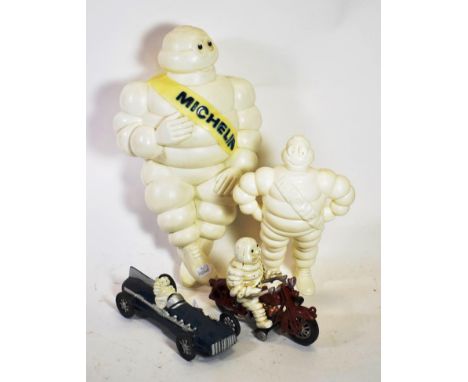 A Metal Cast Michelin Advertising Figures, comprising the Michelin man with a yellow sash with blue lettering, seated on a re