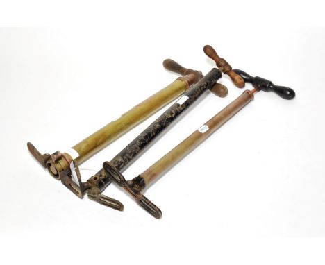 A Vintage Brass Tyre Inflator, with wooden handle labelled The Dunlop Double Acting Pump No.1 Made in England, with folding m