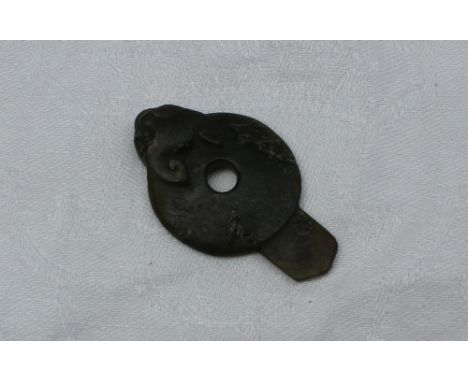 Property of a Viscount: A Jade pendant of flattened spherical form carved with the head of a bat, 6.5cm long CONDITION REPORT