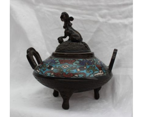 A Chinese bronze and champleve enamel twin handled Koro, with a dog of foo with paw on a ball, the body decorated in turquois