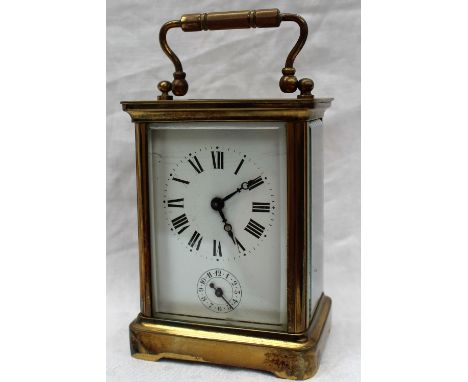 A brass carriage clock, the enamel dial with Roman numerals and an alarm dial, with a lever platform escapement striking on a