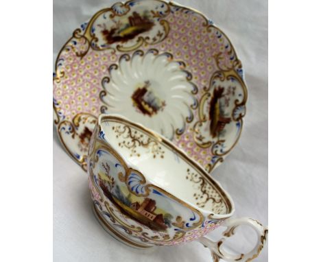 A 19th century English porcelain tea cup and saucer, painted with vignettes of cottages, to a raised pink floral moulded patt